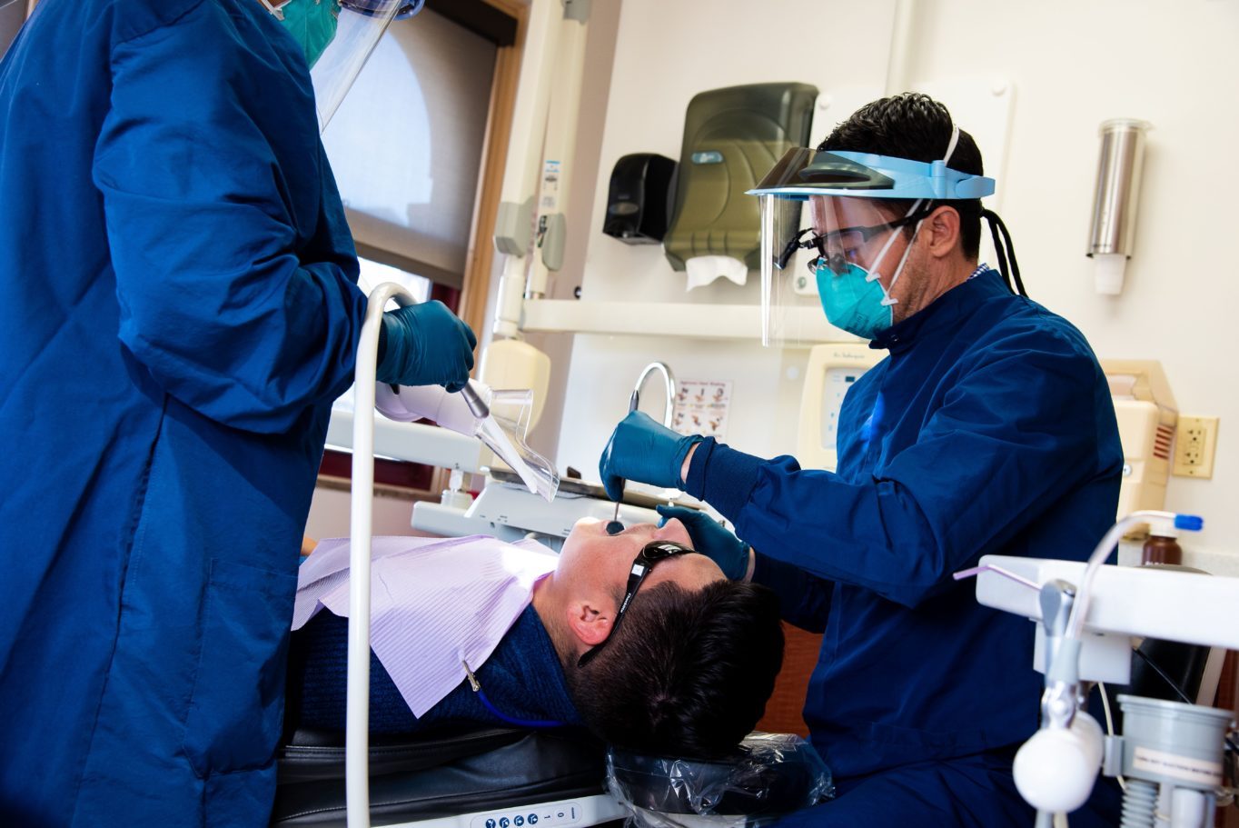 A dentists working on a patient