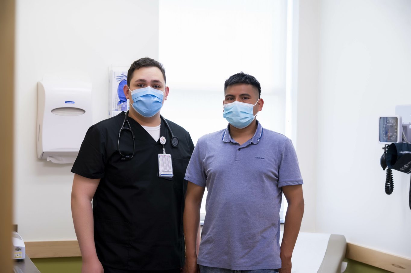 Adrian Fernandez, Quick Sick Clinical Services Supervisor, with Hugo, OneWorld patient.