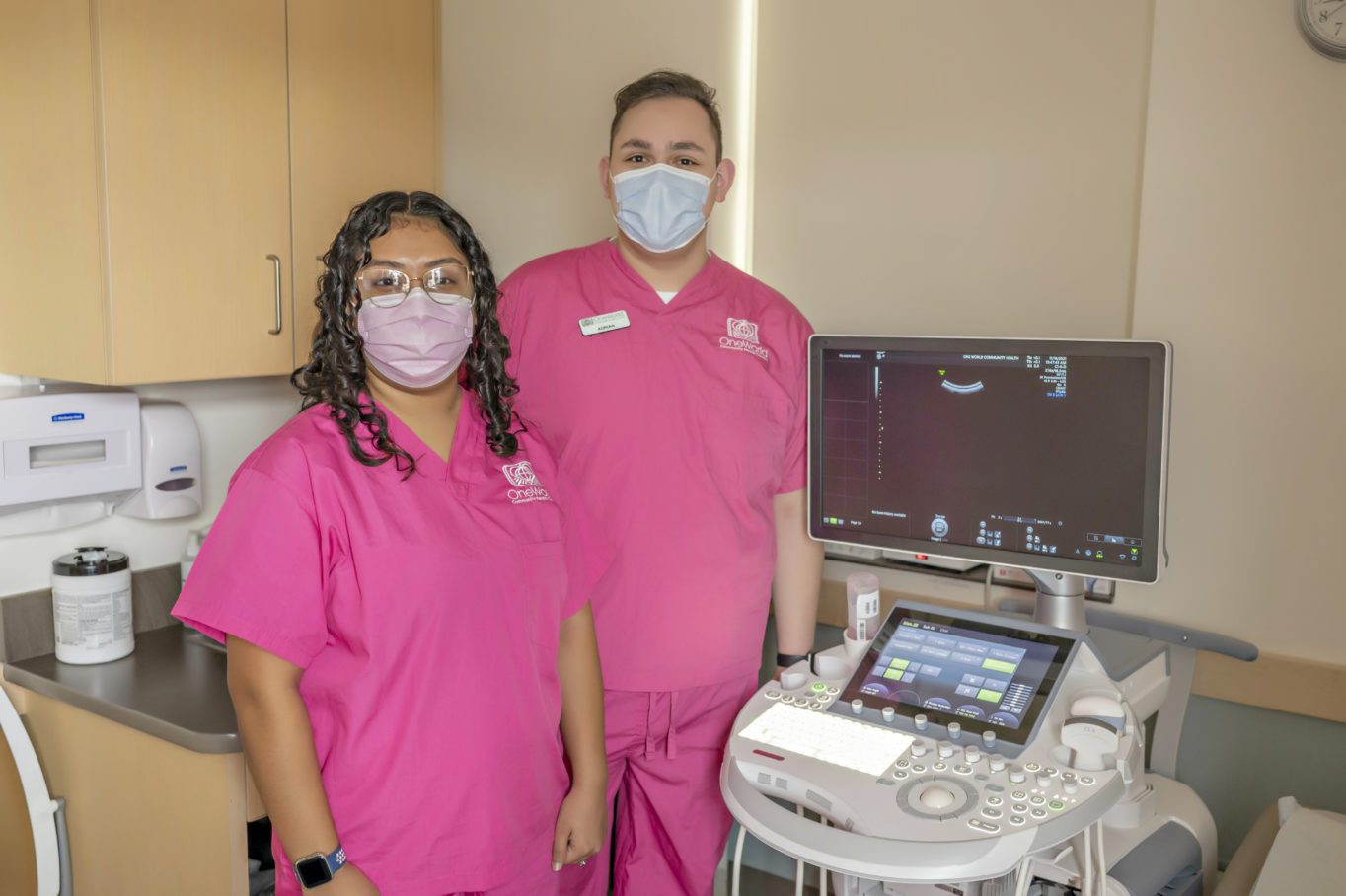 Women’s Health team members by an ultrasound machine.