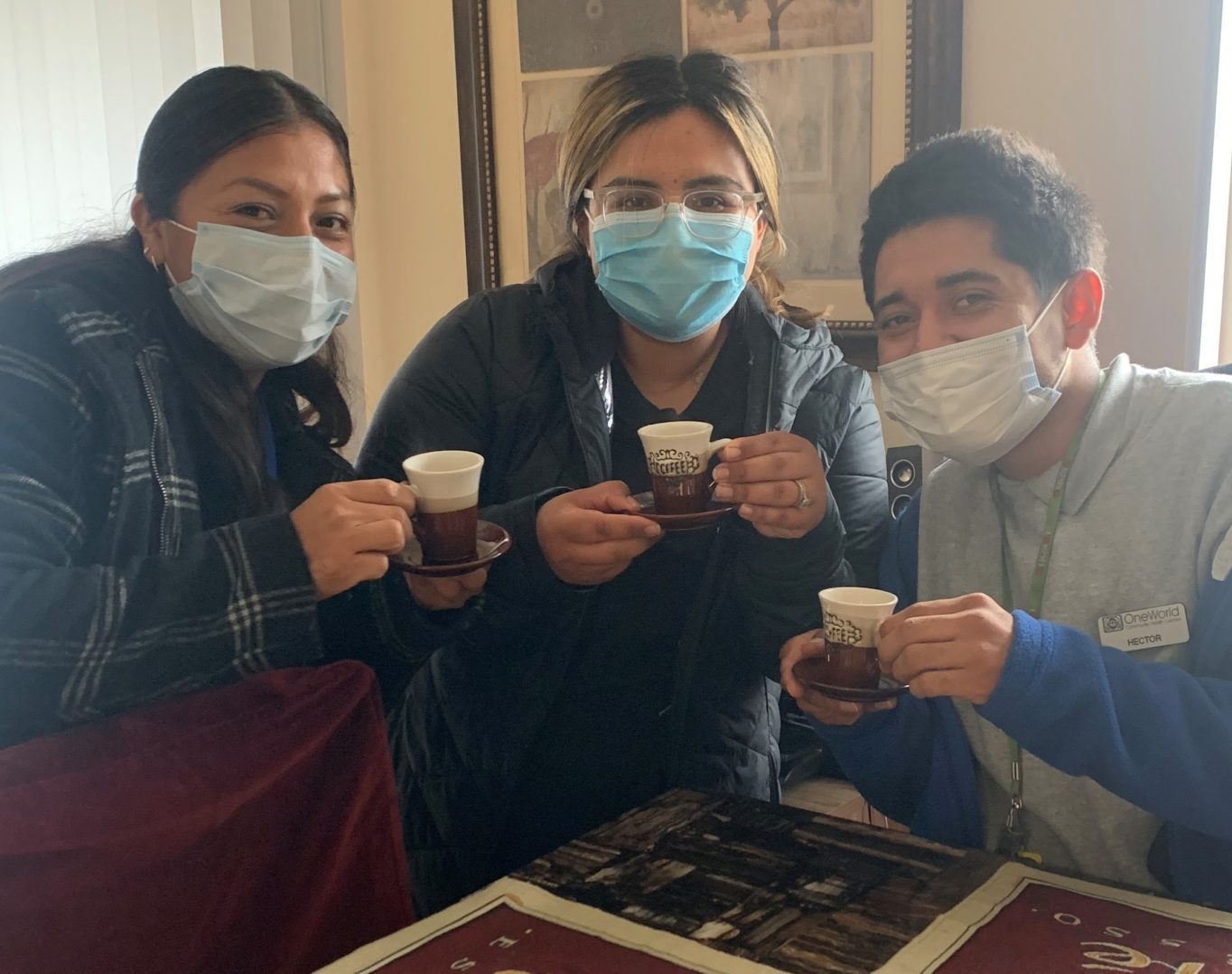 Veronica, Ximena and Hector having espresso with a patient during a home visit.
