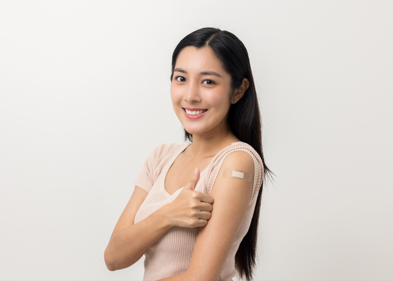 A young woman with a bandage on her arm