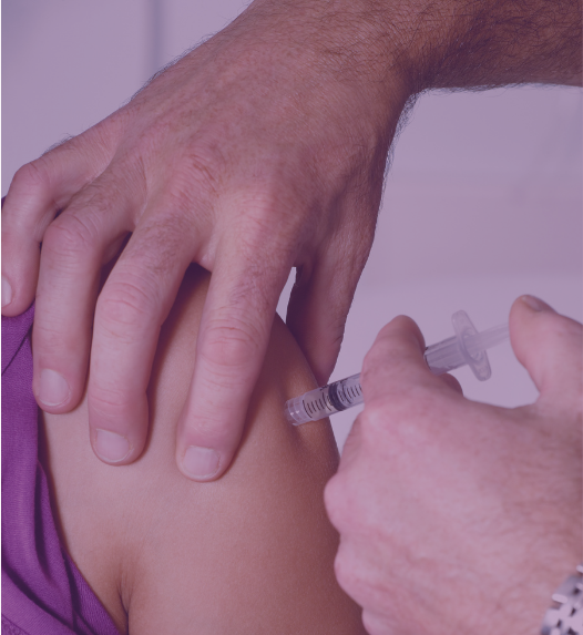 A close-up of a person getting an injection on their upper arm