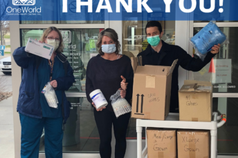 A group of people wearing face masks holding medical supplies