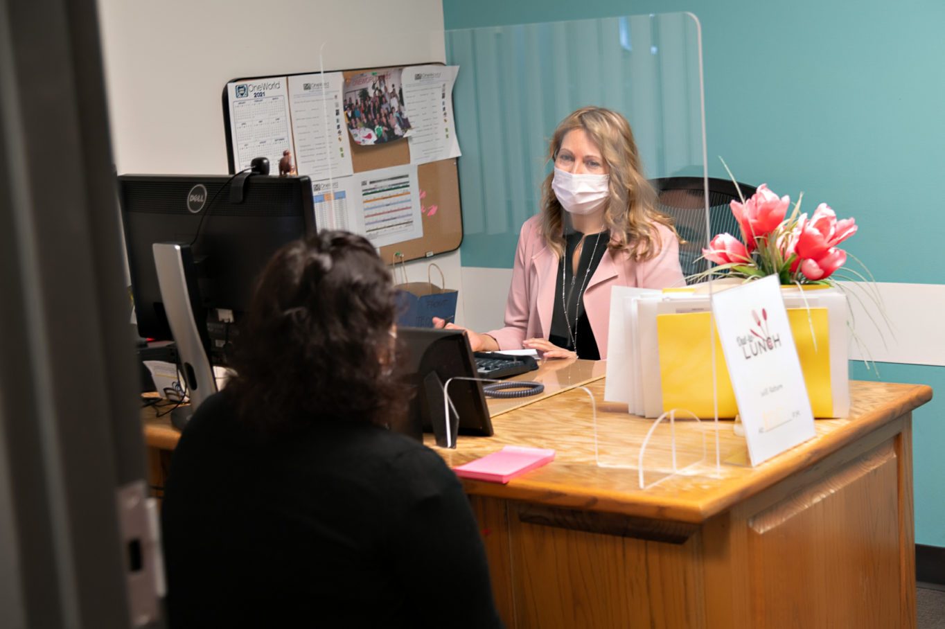 Teresa Chavez, Enrollment and Financial Services Supervisor, consults with OneWorld patient.