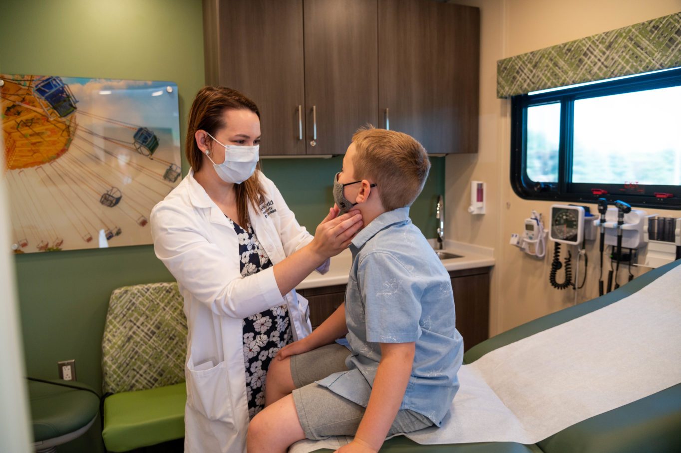 Mindee Swanson with a young boy patient on the Medical Mobile. 