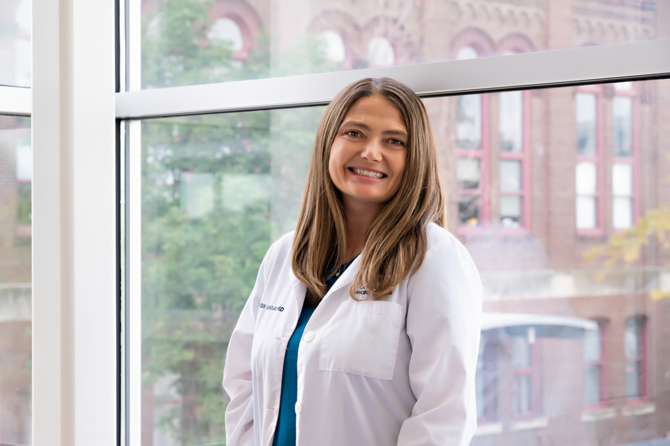 Dr. Shannon Kinnan, Psychiatrist standing by a window inside of a building