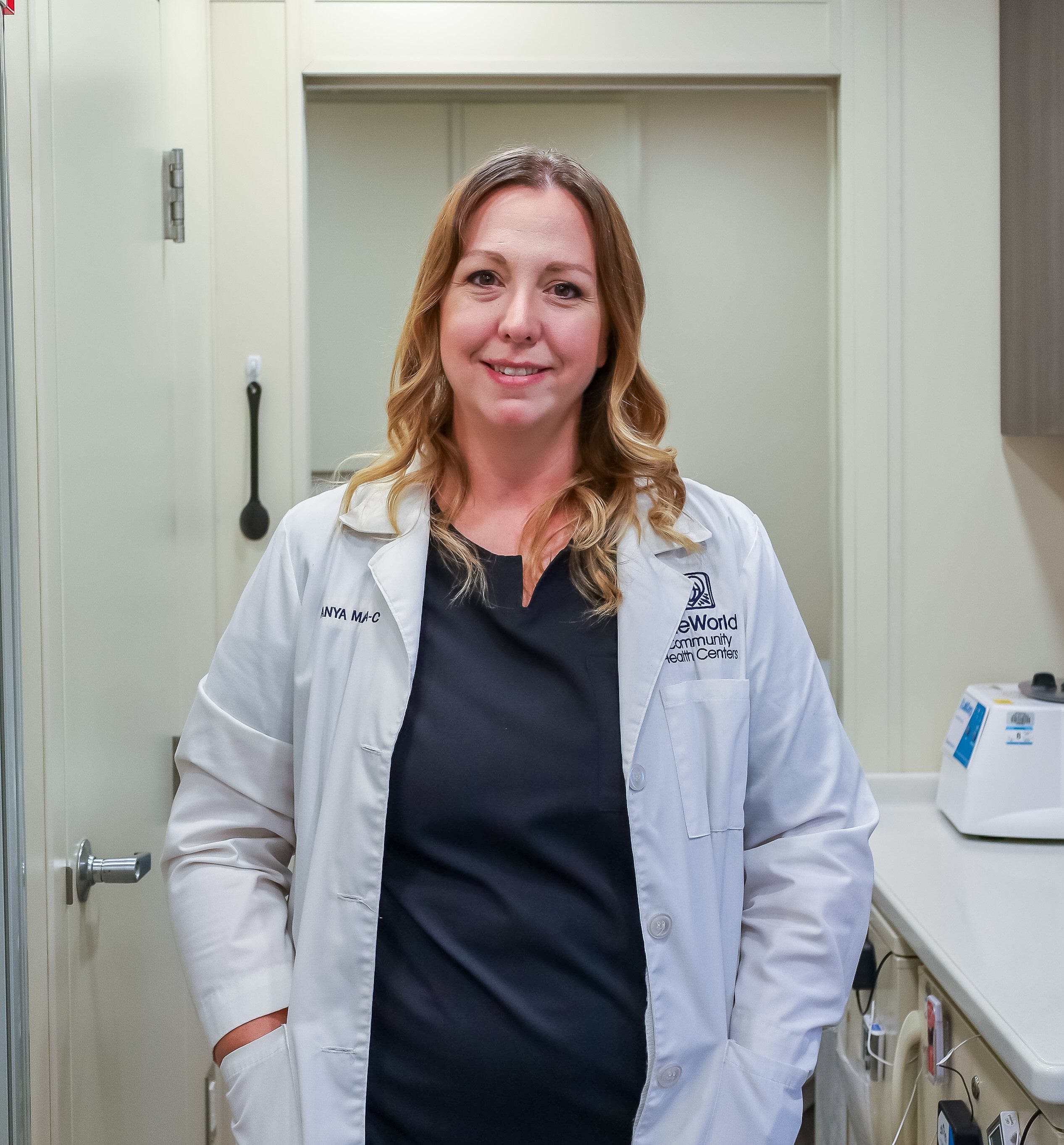 Medical provider Tanya Martin standing in a clinic room smiling