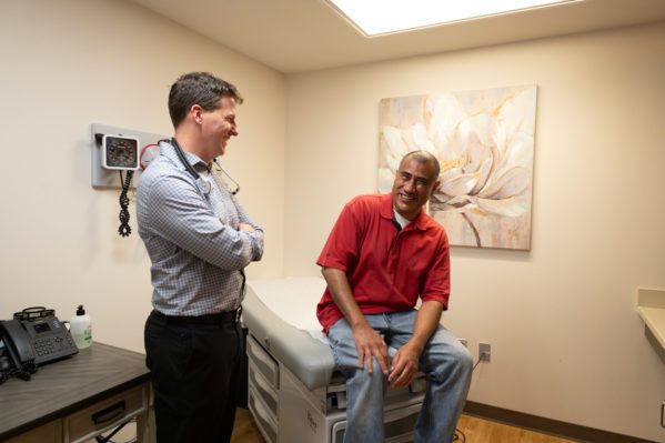 Clinician talking to patient in exam room