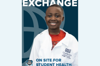 On the cover of this issue, a student smiles while wearing a doctor's coat. The headline of the issue is 